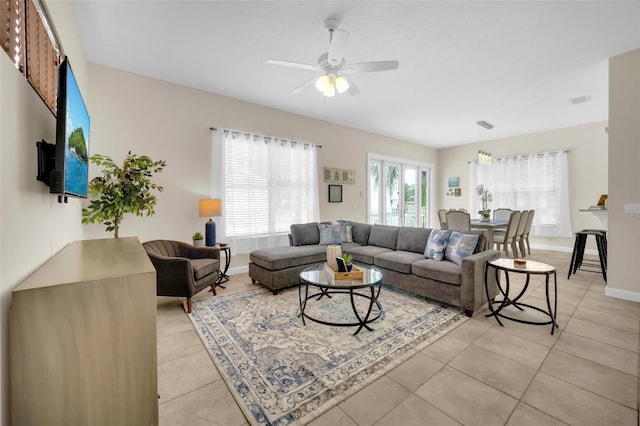 tiled living room with ceiling fan