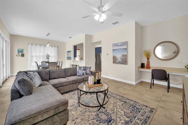 living room with ceiling fan and light tile patterned floors