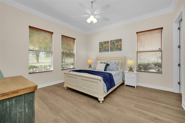 bedroom with multiple windows, ceiling fan, wood-type flooring, and ornamental molding