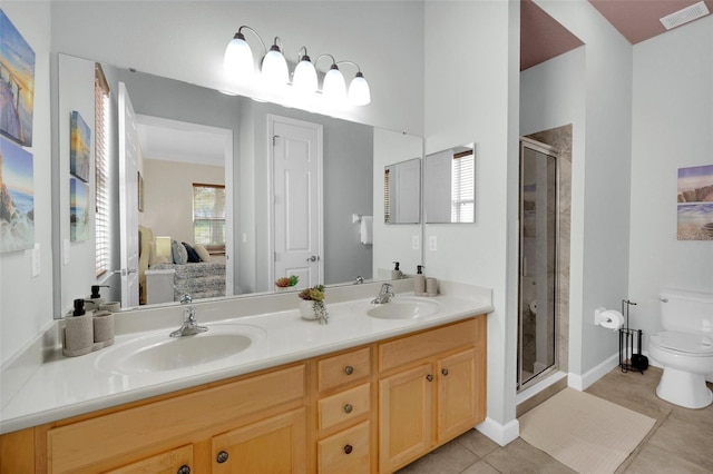 bathroom with walk in shower, tile patterned floors, vanity, and toilet