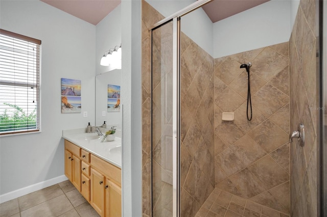 bathroom with vanity, tile patterned floors, walk in shower, and a healthy amount of sunlight