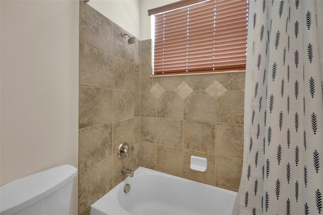 bathroom featuring shower / bath combination with curtain and toilet