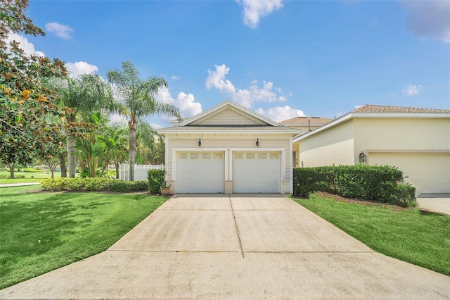 view of front of home with a garage and a front lawn