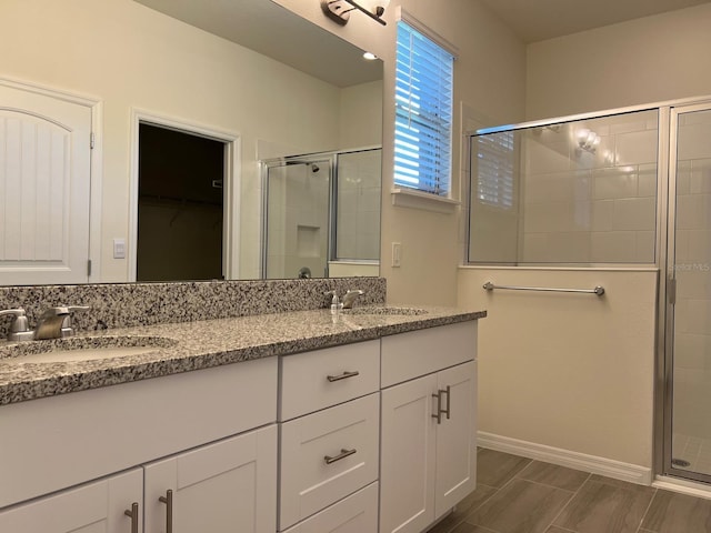 bathroom featuring an enclosed shower and vanity