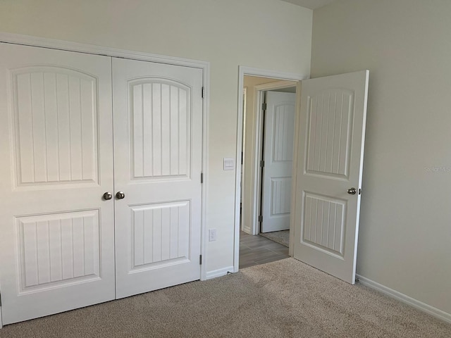 unfurnished bedroom featuring a closet and carpet floors