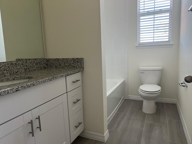 full bathroom featuring bathtub / shower combination, vanity, and toilet