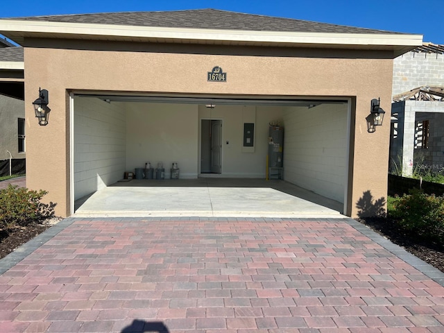 garage with electric water heater and electric panel