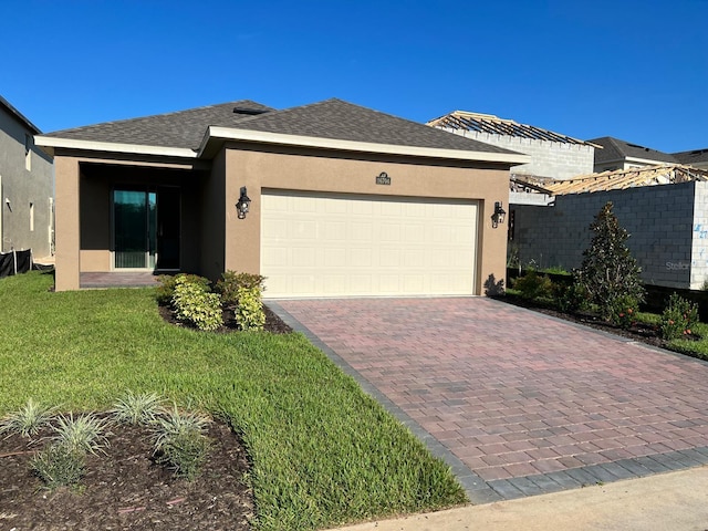 view of front of house featuring a garage and a front lawn