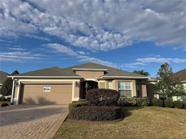 view of front facade featuring a front yard and a garage