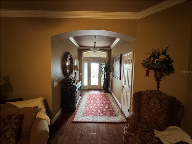 foyer entrance with dark hardwood / wood-style floors and ornamental molding