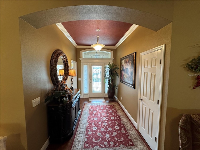 doorway featuring hardwood / wood-style floors, ornamental molding, and a textured ceiling