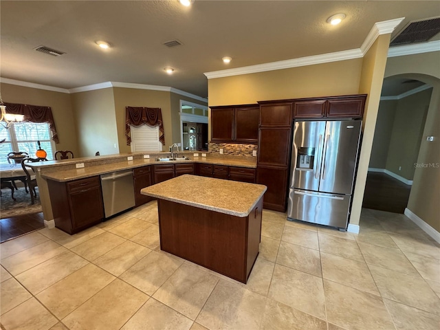 kitchen featuring arched walkways, stainless steel appliances, visible vents, a sink, and dark brown cabinets