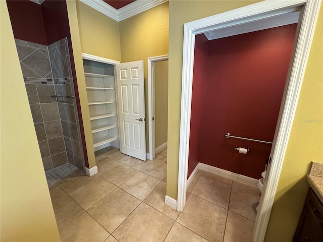 full bathroom with toilet, ornamental molding, a shower stall, tile patterned flooring, and baseboards