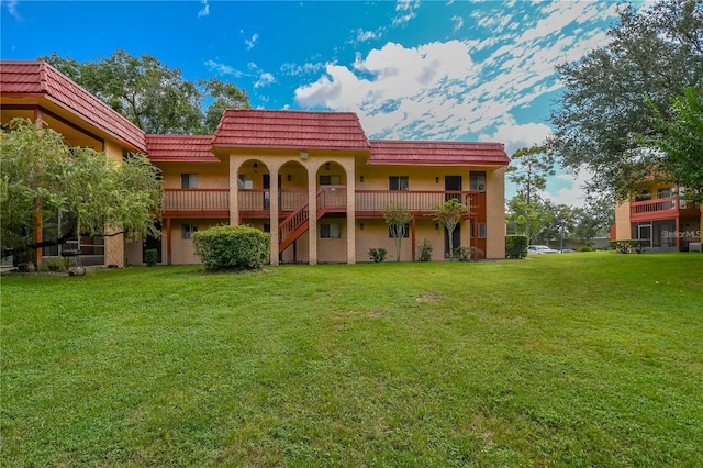 back of house with a lawn