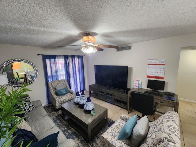 tiled living room with ceiling fan and a textured ceiling