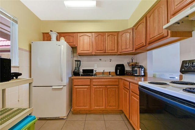 kitchen with white appliances, sink, light tile patterned floors, tasteful backsplash, and extractor fan