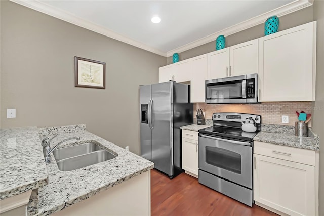 kitchen with light stone countertops, sink, white cabinetry, and stainless steel appliances