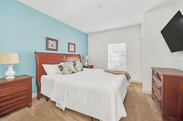 bedroom featuring light carpet