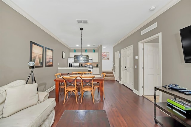 dining area featuring crown molding and dark wood-type flooring