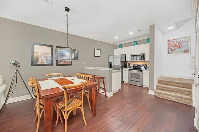 dining space featuring dark hardwood / wood-style flooring and crown molding