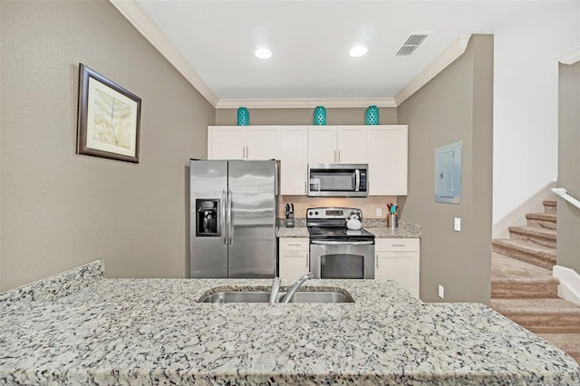 kitchen with sink, white cabinetry, ornamental molding, and appliances with stainless steel finishes