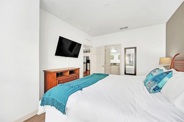 bedroom with carpet floors and ensuite bathroom