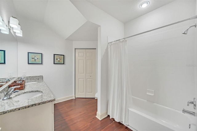 full bathroom with vanity, lofted ceiling, hardwood / wood-style flooring, toilet, and shower / tub combo