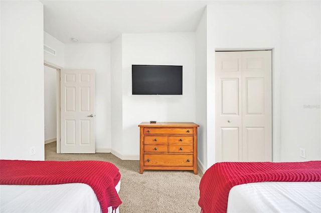 carpeted bedroom featuring a closet