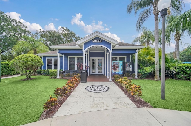 view of front of property featuring french doors and a front lawn