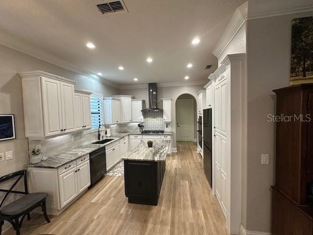 kitchen featuring a center island, wall chimney range hood, sink, decorative backsplash, and black dishwasher