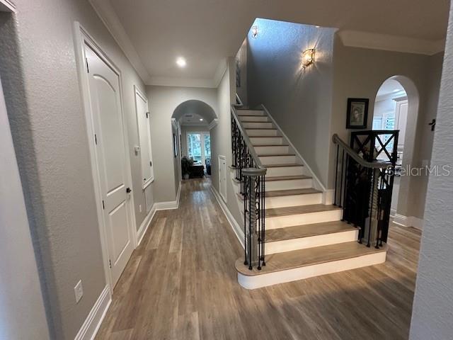 interior space with hardwood / wood-style flooring and ornamental molding