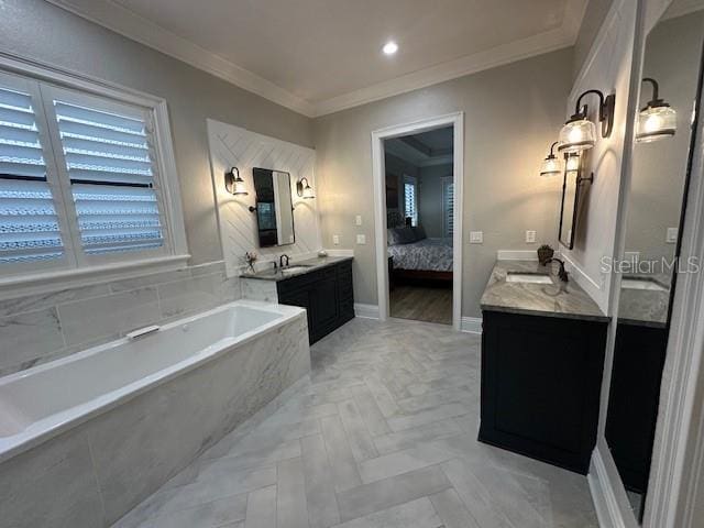 bathroom with vanity, ornamental molding, and tiled tub