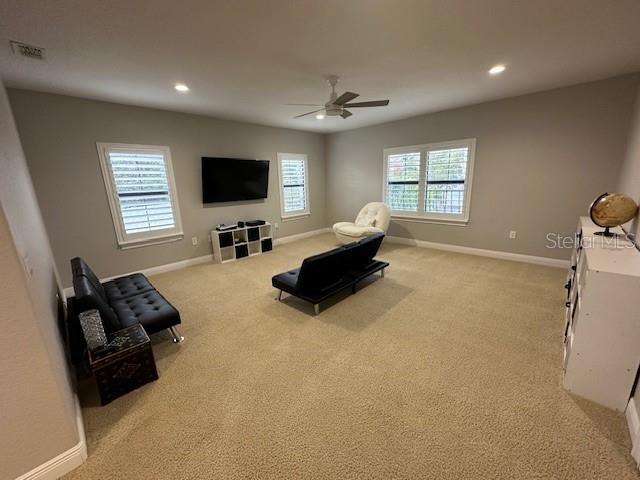 interior space with ceiling fan