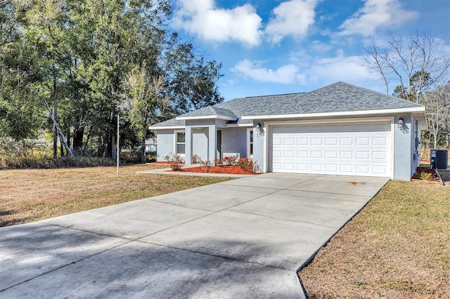 ranch-style house featuring a garage, central AC, and a front lawn