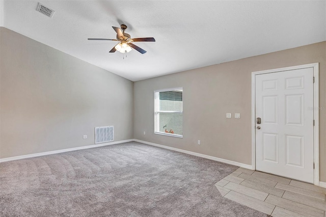 carpeted spare room with ceiling fan