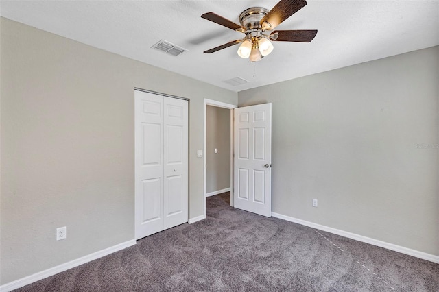 unfurnished bedroom featuring dark carpet, ceiling fan, and a closet