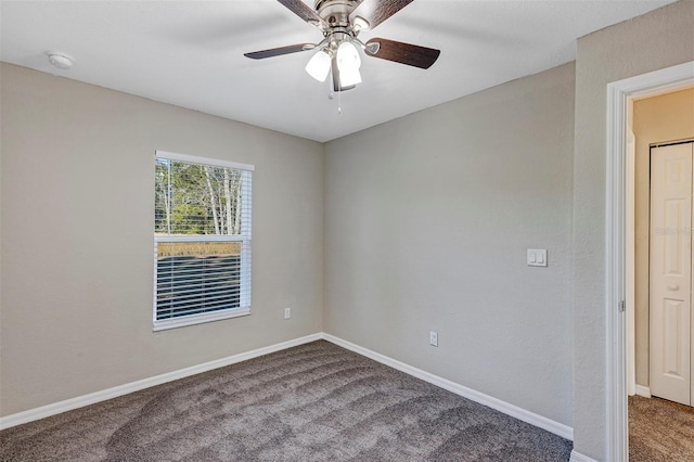 unfurnished room with ceiling fan and carpet