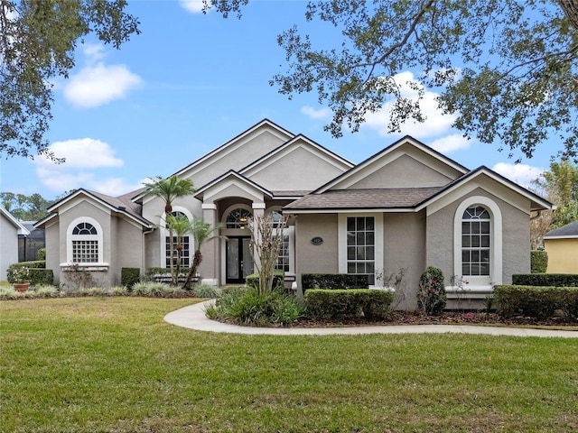 ranch-style home with a front lawn