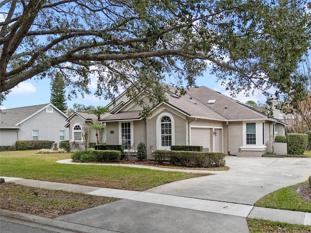 ranch-style home featuring a garage and a front yard