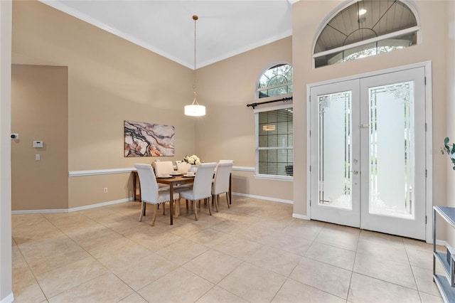 dining area with french doors, ornamental molding, and light tile patterned floors