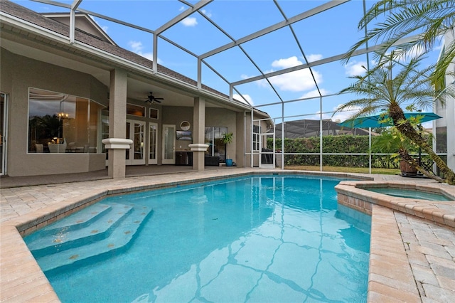 view of swimming pool with an in ground hot tub, a lanai, a patio, and ceiling fan