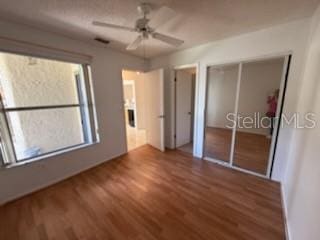 unfurnished bedroom featuring a ceiling fan and wood finished floors