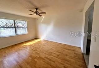 unfurnished room featuring wood finished floors and a ceiling fan