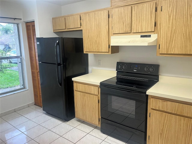 kitchen featuring light tile patterned floors, black appliances, light countertops, and under cabinet range hood