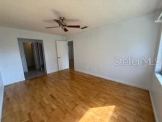 spare room with wood finished floors and a ceiling fan