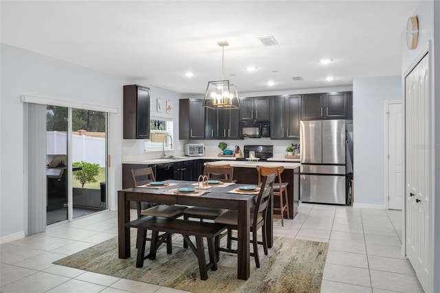 dining room featuring sink and light tile patterned floors