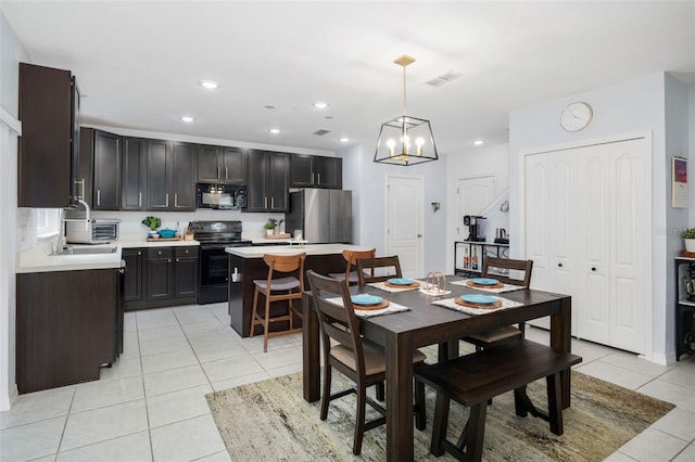 dining area featuring sink and light tile patterned floors