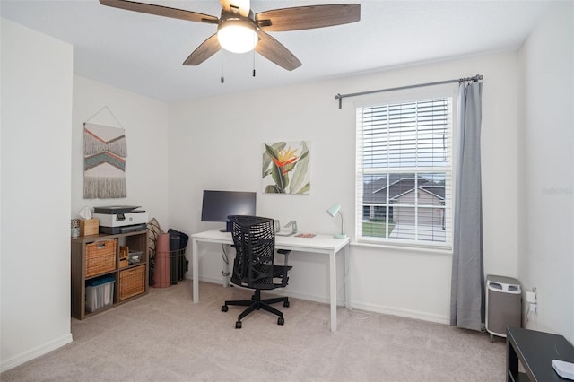 office featuring ceiling fan and light carpet