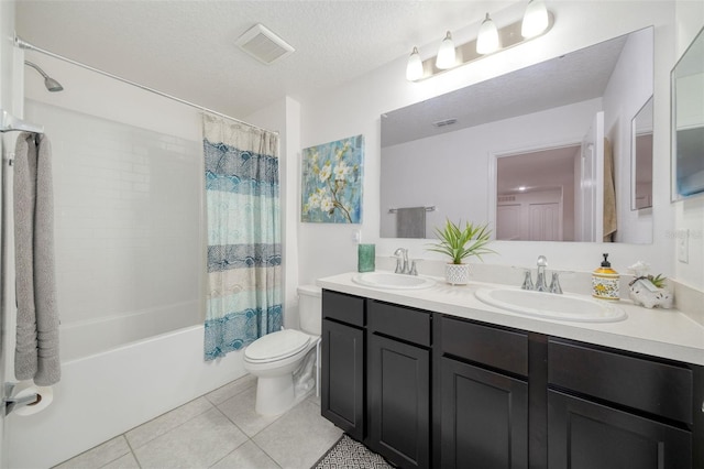 full bathroom with tile patterned flooring, toilet, a textured ceiling, shower / bath combo, and vanity