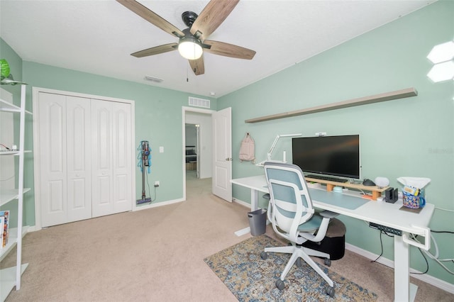 carpeted office with ceiling fan